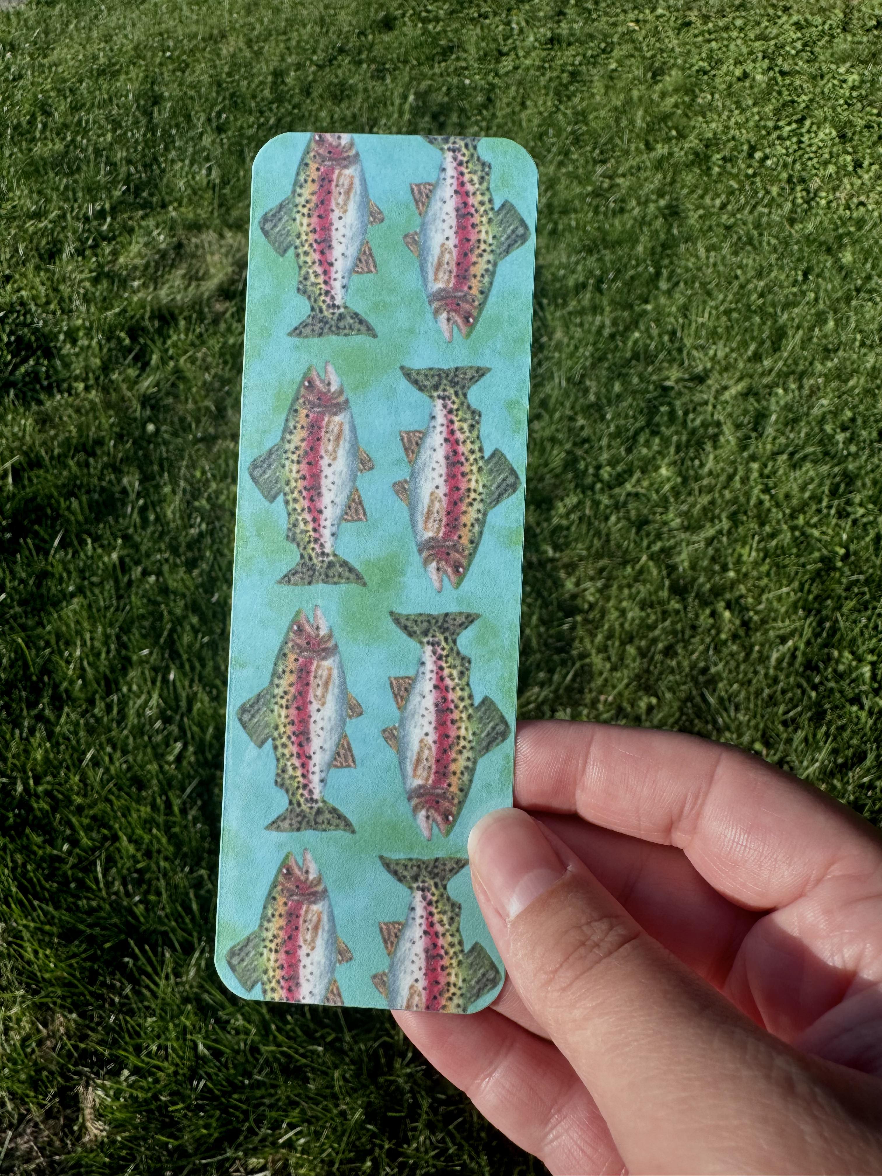 Rainbow trout bookmark with six spotted trout in mirrored pattern on teal background