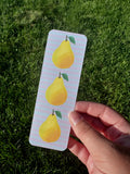 Pear bookmark with three golden yellow pears and green leaves on soft lavender stripe background